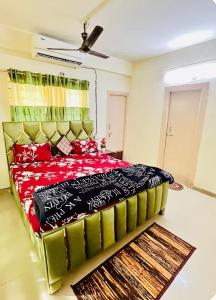 a bedroom with a large bed with red pillows at spice villa hotel in Gajar
