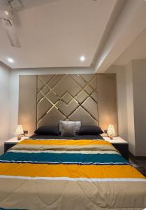 a large bed in a room with two lamps at spice villa hotel in Gajar