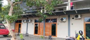 a motorcycle parked in front of a building at Cozzee AnD in Labuan Bajo +14 photos