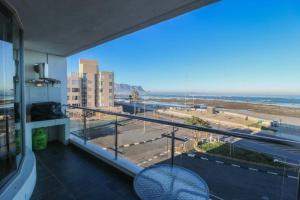a balcony with a table and a view of the beach at 302 Hibernian Towers Self Catering Accommodation in Strand