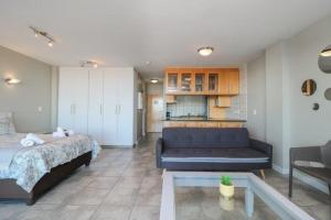 a living room with a bed and a couch at 302 Hibernian Towers Self Catering Accommodation in Strand