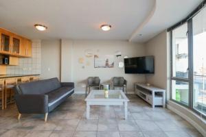 a living room with a couch and a table at 302 Hibernian Towers Self Catering Accommodation in Strand