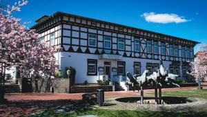 a building with a statue in front of it at Deutsches Haus Munster in Munster