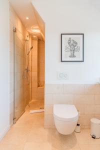 a bathroom with a toilet and a shower at Waaster Bob in Oldsum +30 photos