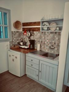a kitchen with a sink and a counter top at Fotinis Apartment in Kalymnos