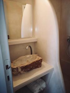 a bathroom with a sink and a mirror at Fotinis Apartment in Kalymnos