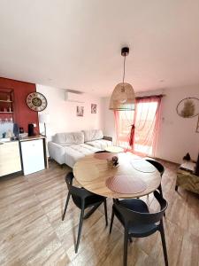 a living room with a table and a couch at Gîte chez EsTé in Mittelwihr