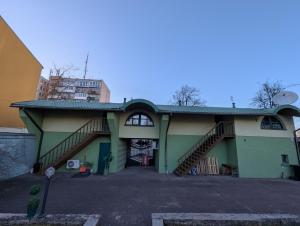 a building with a staircase in a parking lot at Cousy Center House in Šiauliai
