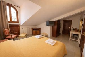 a large bedroom with a yellow bed in a room at Euro Hotel Iglesias in Iglesias