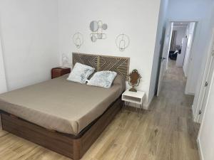 a bedroom with a bed with two pillows on it at Piso Loli in Águilas