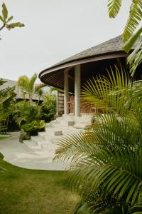a building with a bunch of stairs in front of it at Sejati Boutique Hotel Uluwatu in Uluwatu