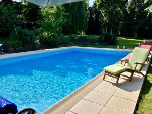 a swimming pool with two lounge chairs next to it at Mis Harand in Litteau