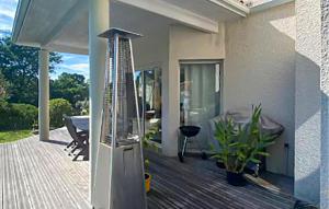 a porch of a house with a glass door at Belle Maison Avec Piscine in Arcachon