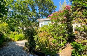 a house with bushes and flowers in front of it at Belle Maison Avec Piscine in Arcachon +13 photos