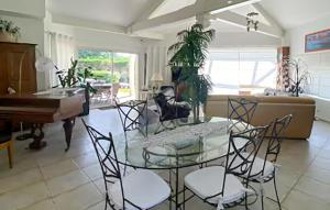 a living room with a table and chairs and a piano at Belle Maison Avec Piscine in Arcachon
