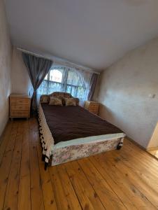 a bedroom with a bed in a room with a window at Cousy Center House in Šiauliai