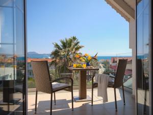 a patio with a table and chairs on a balcony at Athina Studios in Laganas