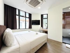 a large white bed in a room with windows at Aura Hotel Mackenzie in Singapore +16 photos