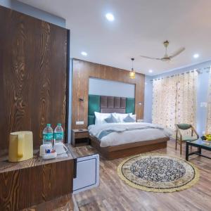 a bedroom with a large bed and a table with a table at Hotel Your Hive in Srinagar