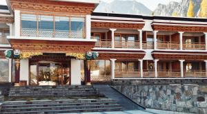 a building with mountains in the background at Kaldan Palace in Hundar