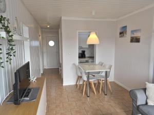 a living room and kitchen with a table and chairs at Feriengarten Dahme W 22 in Dahme
