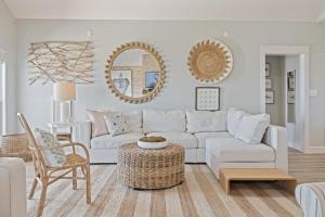 a white living room with a white couch and mirrors at Gulf State home in Crystal Beach +54 photos