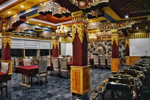 a dining room with tables and chairs in it at Kaldan Palace in Hundar