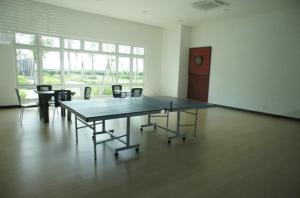 a ping pong table in a room with chairs at Pearl Regency Super Condominium in Gelugor +11 photos