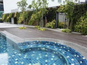 a swimming pool in the middle of a building at Pearl Regency Super Condominium in Gelugor