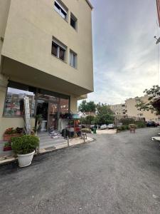 a store front of a building with a parking lot at Zea Apartments in Himare