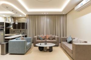 a living room with two couches and a table at Topaz Serviced Apartments in Riyadh