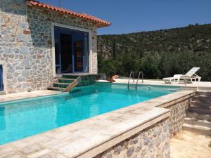 a villa with a swimming pool and a house at villa olivedream in Nea Epidavros +82 photos