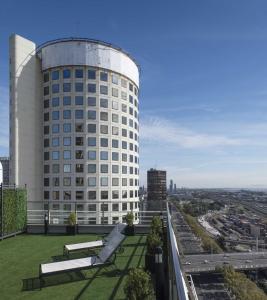 a white building with benches on a roof at Emperador Hotel Buenos Aires in Buenos Aires
