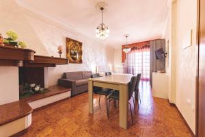 a living room with a table and a couch at Porto Cesareo - Appartamenti e camere in Porto Cesareo