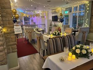 a dining room with tables and chairs and balloons at Peasehill StMichaels in Rawdon