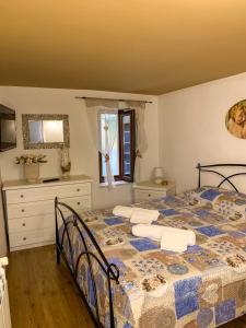 a bedroom with a bed with a blue and white comforter at Domus Serena in Venafro