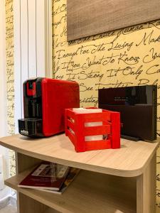 a table with a red briefcase and a box on it at Domus Serena in Venafro