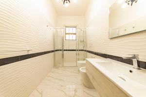 a bathroom with a shower and a sink and a toilet at Porto Cesareo - Appartamenti e camere in Porto Cesareo +43 photos