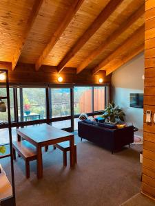 a living room with a table and a couch at No 43 Guesthouse in Mount Beauty