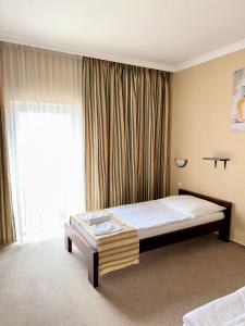 a bedroom with a bed and a large window at Restaurant and Pension Stenly in Spišský Štvrtok +21 photos