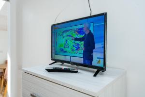 a flat screen tv sitting on top of a dresser at Stay Bergamo Centro in Bergamo