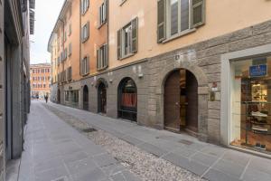 an empty street in a city with buildings at Stay Bergamo Centro in Bergamo