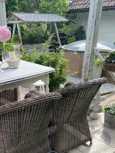 a patio with a table and wicker chairs at Ranczo in Smołdzięcino