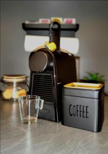 a coffee maker and a glass on a table at Apartment mit Rheinblick Koblenz in Koblenz
