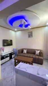 a living room with a couch and a blue ceiling at Westwood Homes in Kilifi