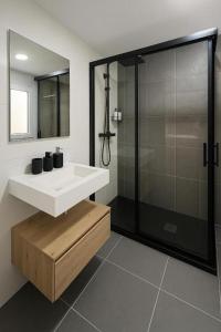 a bathroom with a sink and a shower at Nova Suites Viveiro in Viveiro