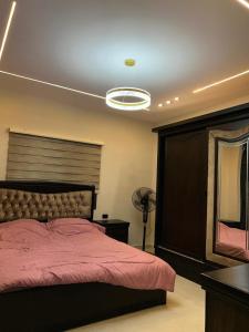 a bedroom with a bed with a red comforter at سبانا شاليه in Jerash +75 photos