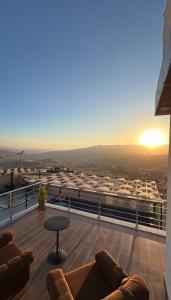 a balcony with couches and a table on a building at سبانا شاليه in Jerash