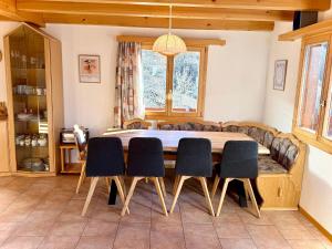 a dining room with a table and four chairs at Chalet Charis in Bellwald