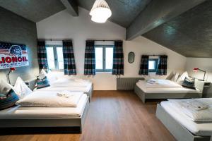 a large room with three beds and a couch at FAT Mankei in Seidlwinkl